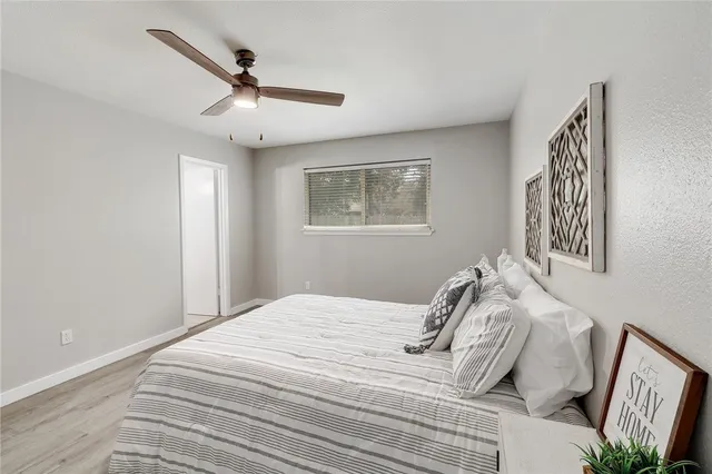 a bedroom with a large bed and a window