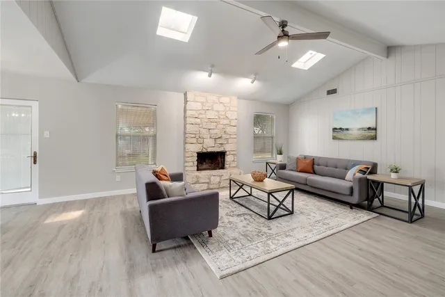 a living room with furniture and a fireplace