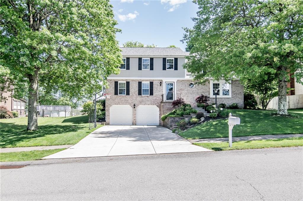 104 Bertley Ridge Drive Coraopolis, PA 15108 - Photo 1 of 25 a front view of a house with a yard and garage