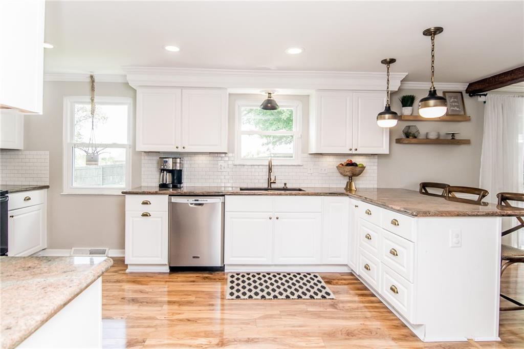 104 Bertley Ridge Drive Coraopolis, PA 15108 - Photo 2 of 25 a kitchen with stainless steel appliances granite countertop a sink stove and white cabinets