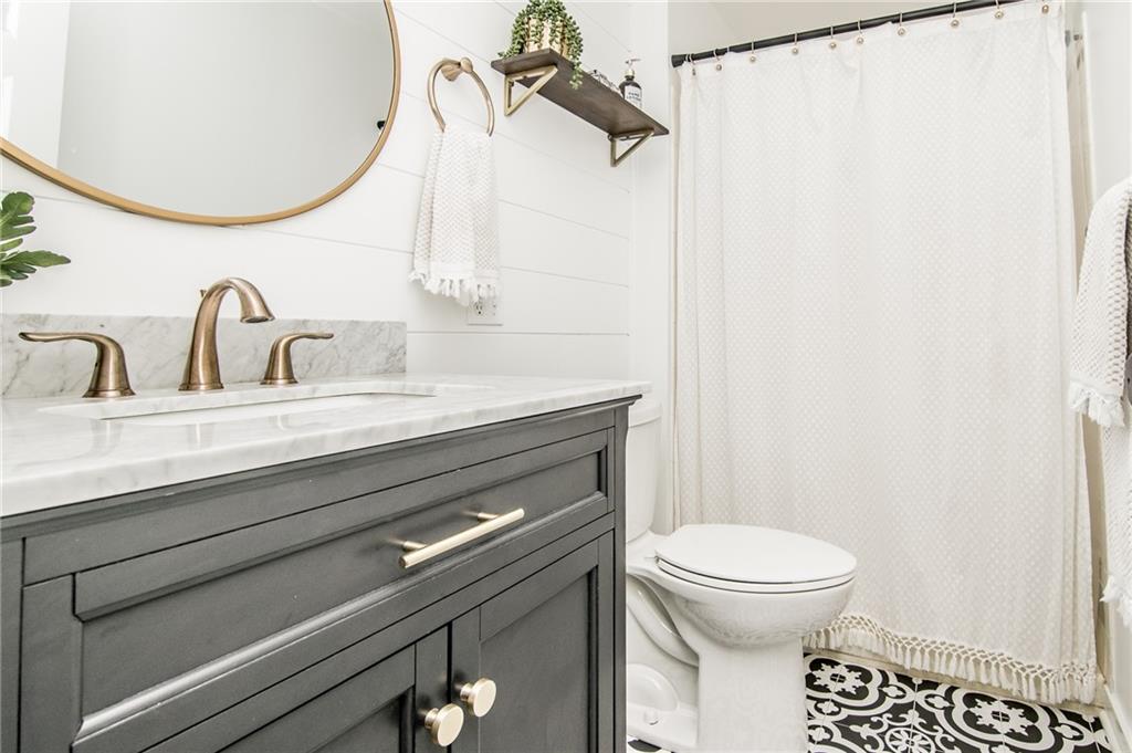 104 Bertley Ridge Drive Coraopolis, PA 15108 - Photo 11 of 25 a bathroom with a sink a toilet and a mirror