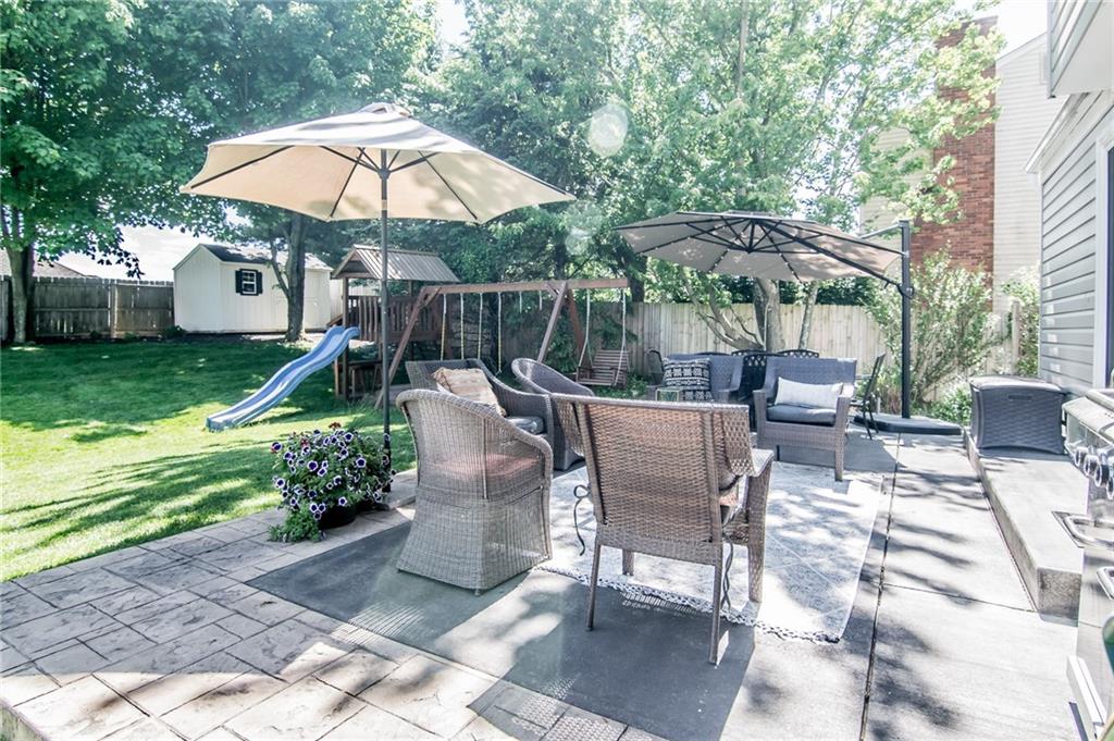 104 Bertley Ridge Drive Coraopolis, PA 15108 - Photo 24 of 25 a view of a patio with a table and chairs under an umbrella