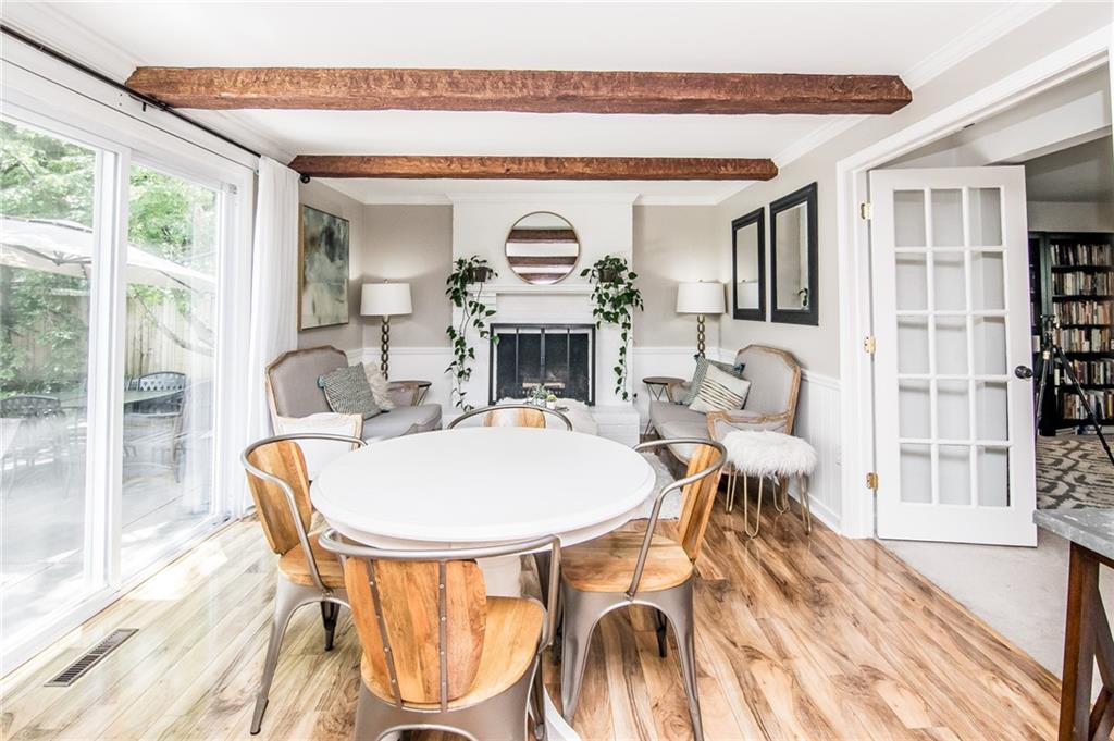 104 Bertley Ridge Drive Coraopolis, PA 15108 - Photo 5 of 25 a living room with a dining table a fireplace and a floor to ceiling window