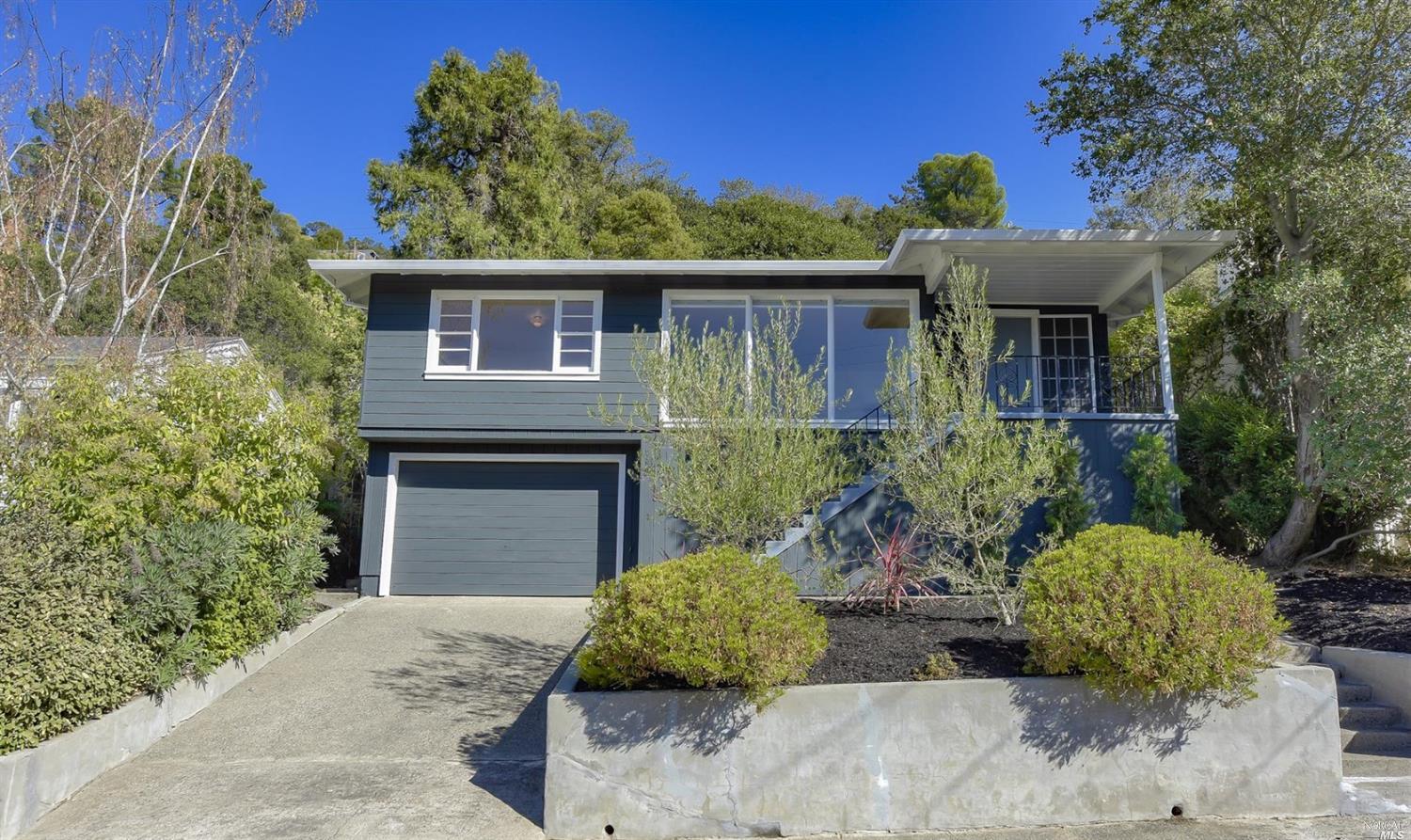 a front view of a house with a garden