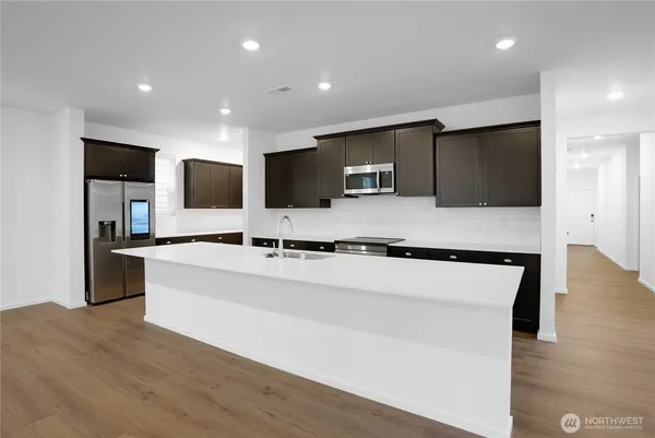 a kitchen with stainless steel appliances a sink stove and refrigerator