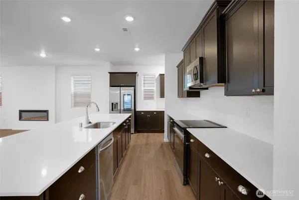 a kitchen with stainless steel appliances sink a microwave and cabinets