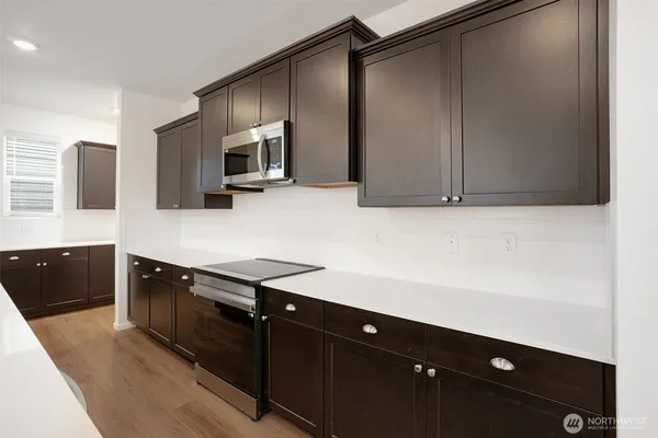 a kitchen with stainless steel appliances a refrigerator and a stove