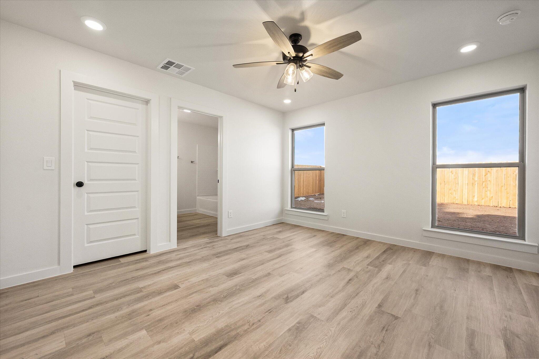 3022 138th Place Lubbock, TX 79423 - Photo 13 of 20 an empty room with wooden floor and windows