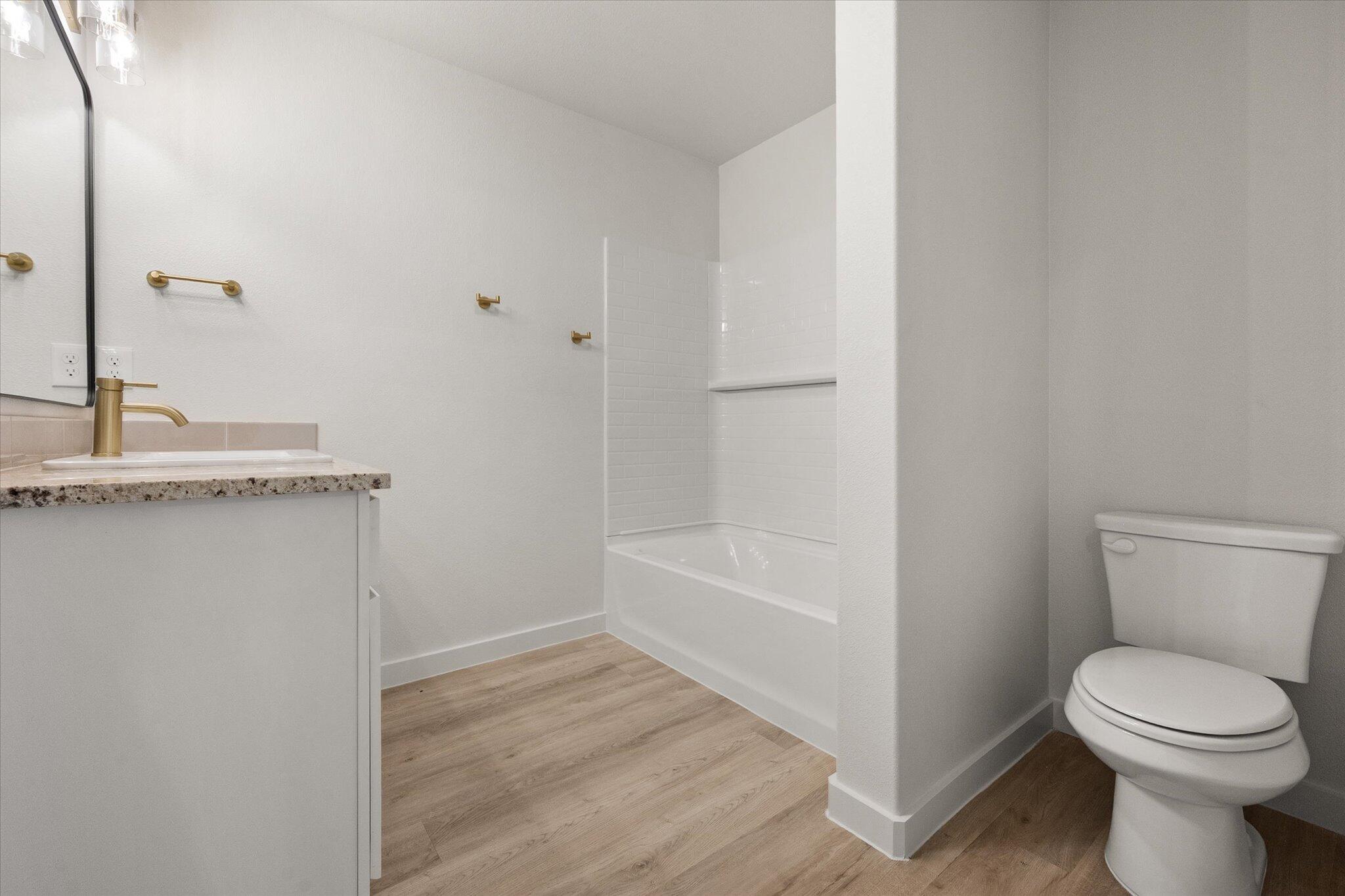 3022 138th Place Lubbock, TX 79423 - Photo 15 of 20 a bathroom with a toilet a sink and bathtub