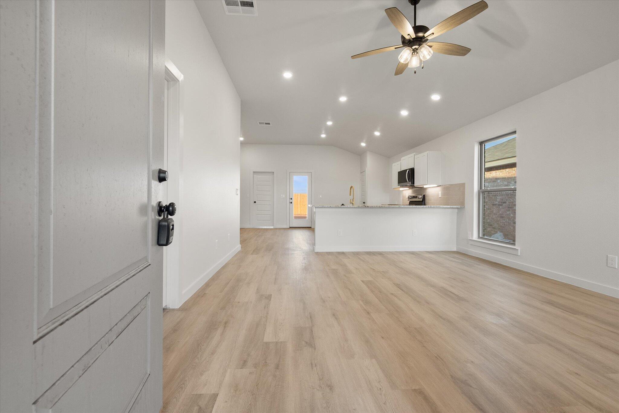 3022 138th Place Lubbock, TX 79423 - Photo 2 of 20 a view of a kitchen with a sink and a refrigerator