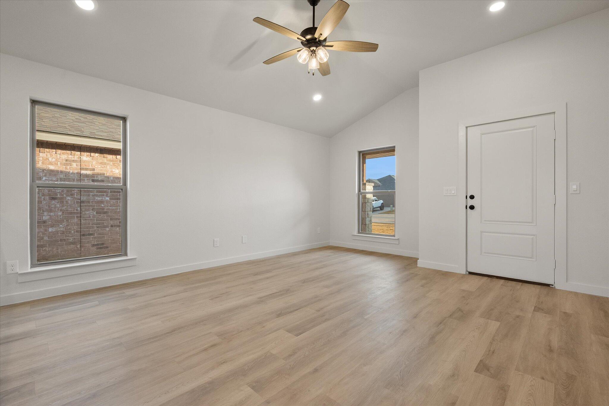 3022 138th Place Lubbock, TX 79423 - Photo 6 of 20 an empty room with fan and windows