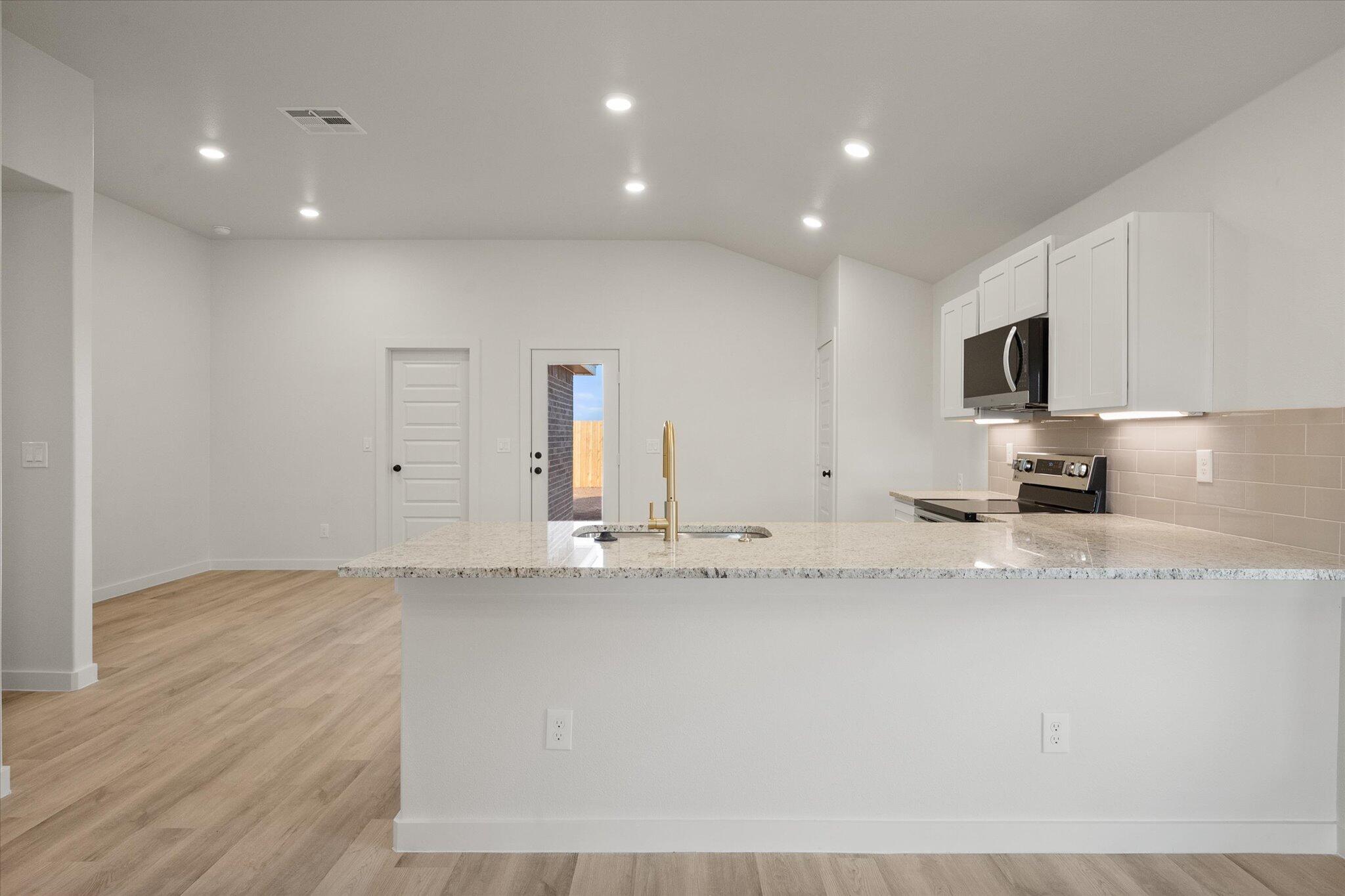 3022 138th Place Lubbock, TX 79423 - Photo 7 of 20 a view of kitchen with granite countertop cabinets and a sink