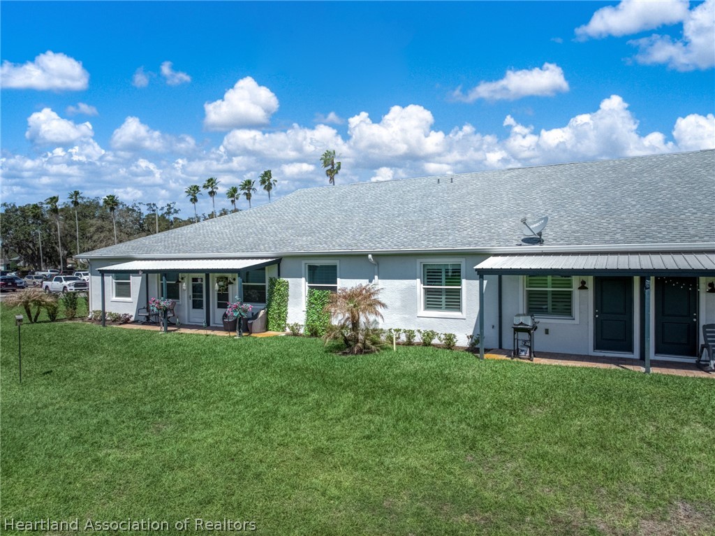 4734 Haw Branch Road, Unit 110 Sebring, FL 33875 - Photo 34 of 50 a view of a house with a yard and sitting area