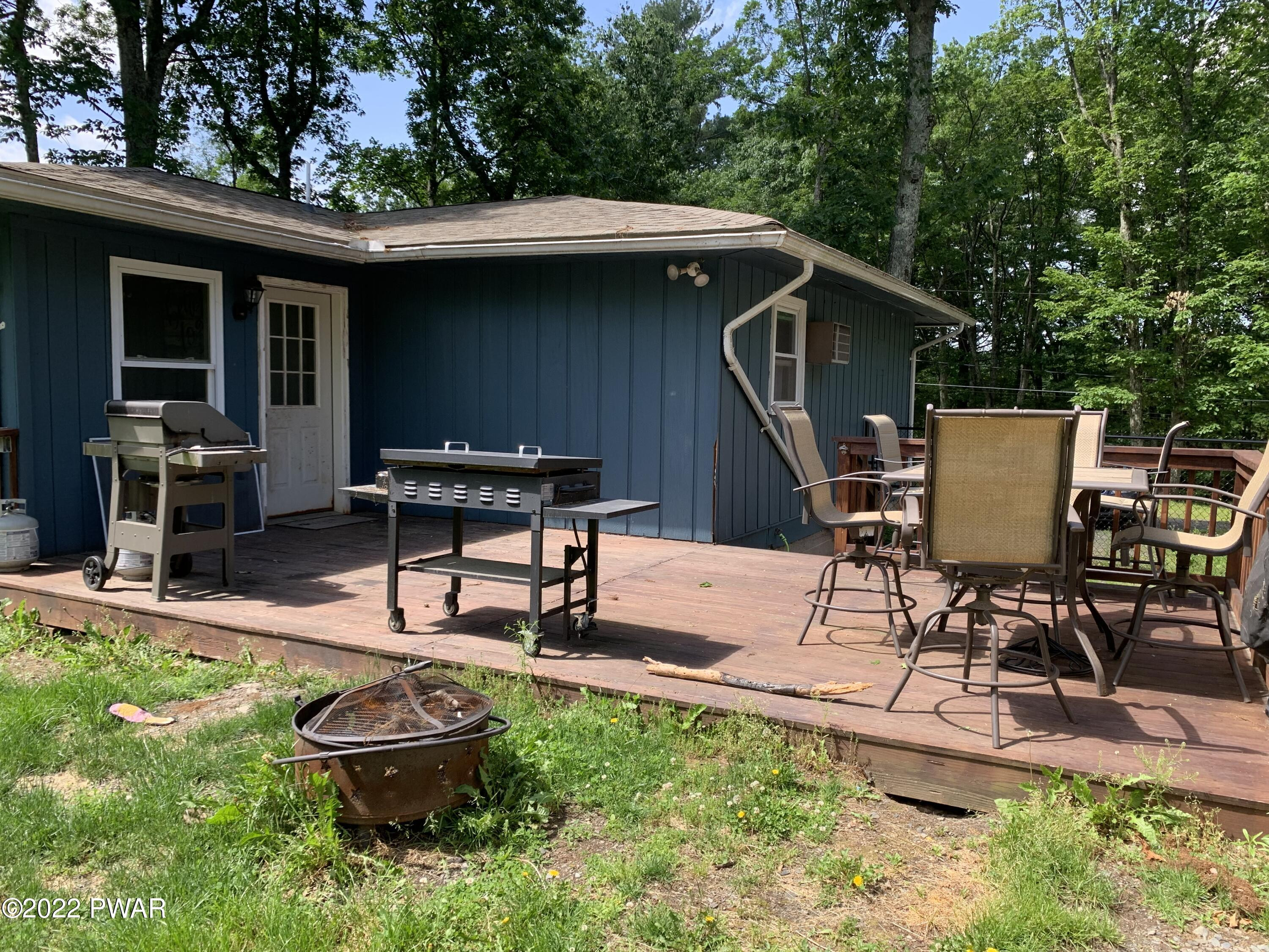 116 Red Pine Road Dingmans Ferry, PA 18328 - Photo 19 of 23 a swimming pool with outdoor seating and yard