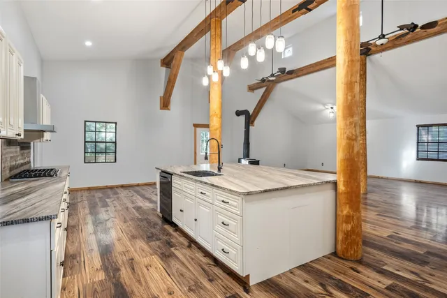 a spacious bathroom with a granite countertop sink a mirror and shower view