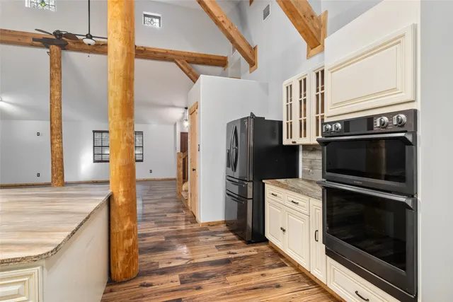 a kitchen with a refrigerator stove and microwave