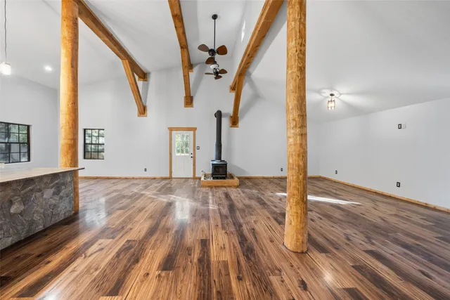a view of a room with wooden floor and staircase