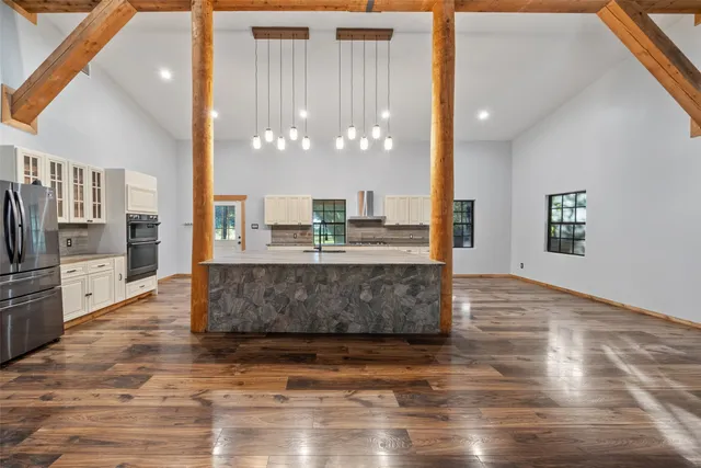 a large kitchen with kitchen island granite countertop a large counter top stainless steel appliances and cabinets