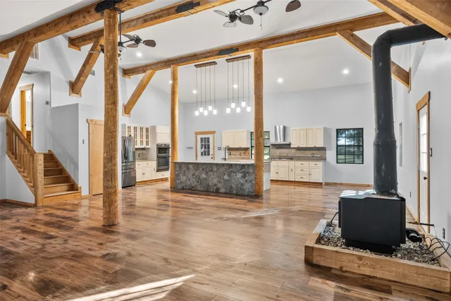 a living room with couches bookshelf and a flat screen tv