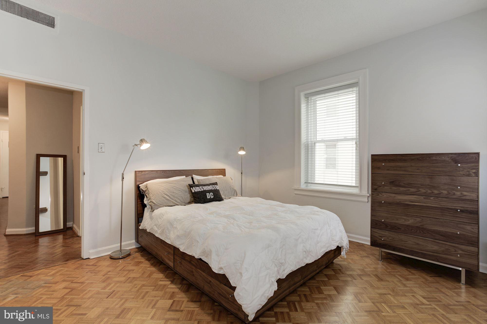 1851 Columbia Road Northwest, Unit 305 Washington, DC 20009 - Photo 12 of 28 a bedroom with a bed and a window