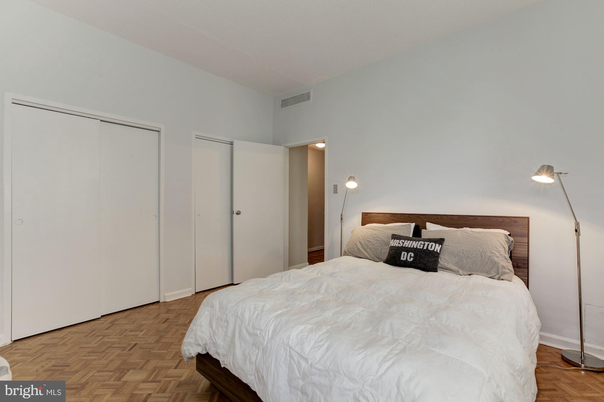 1851 Columbia Road Northwest, Unit 305 Washington, DC 20009 - Photo 13 of 28 a bedroom with a bed and a night stand