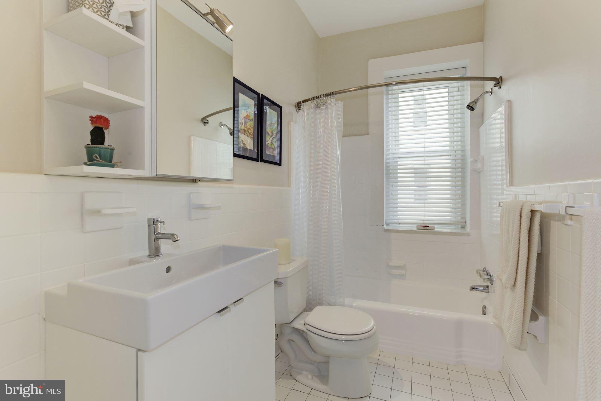 1851 Columbia Road Northwest, Unit 305 Washington, DC 20009 - Photo 14 of 28 a bathroom with a sink toilet and shower