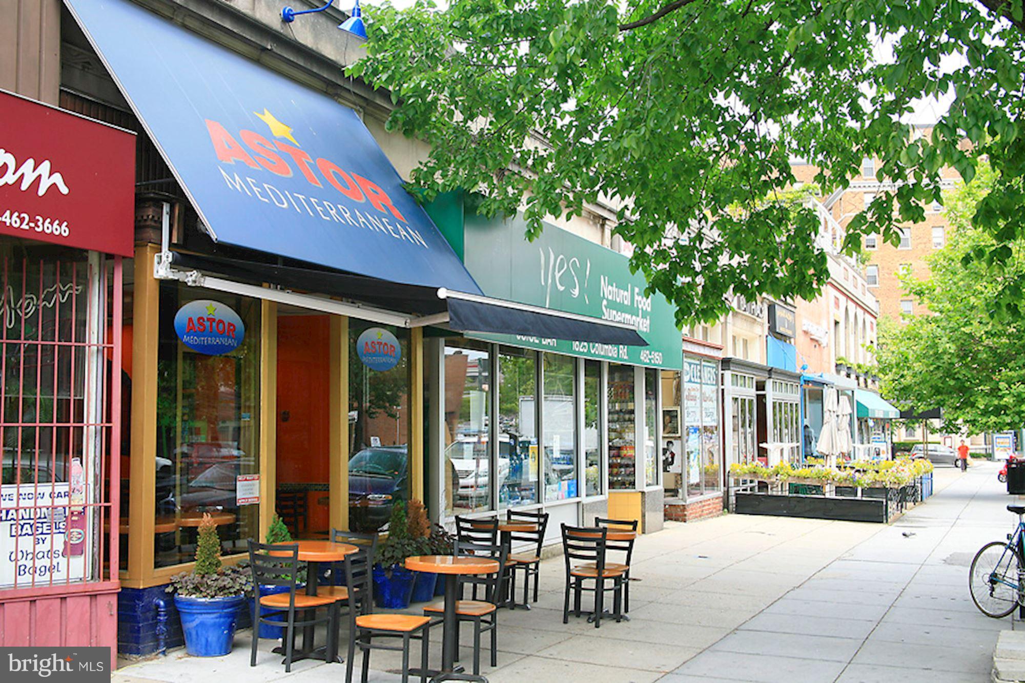 1851 Columbia Road Northwest, Unit 305 Washington, DC 20009 - Photo 22 of 28 a view of a patio with table and chairs and floor to ceiling window