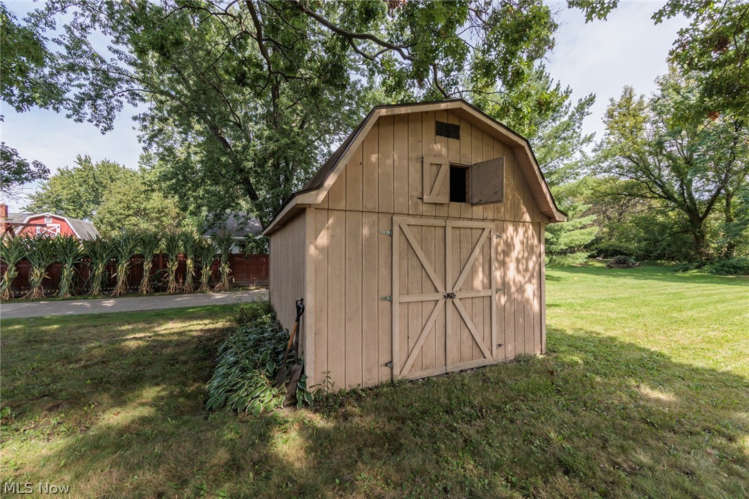 6065 Avon Belden Road North Ridgeville, OH 44039 - Photo 7 of 25 Gable-roof storage shed featuring a wood-panel exterior and double barn doors
