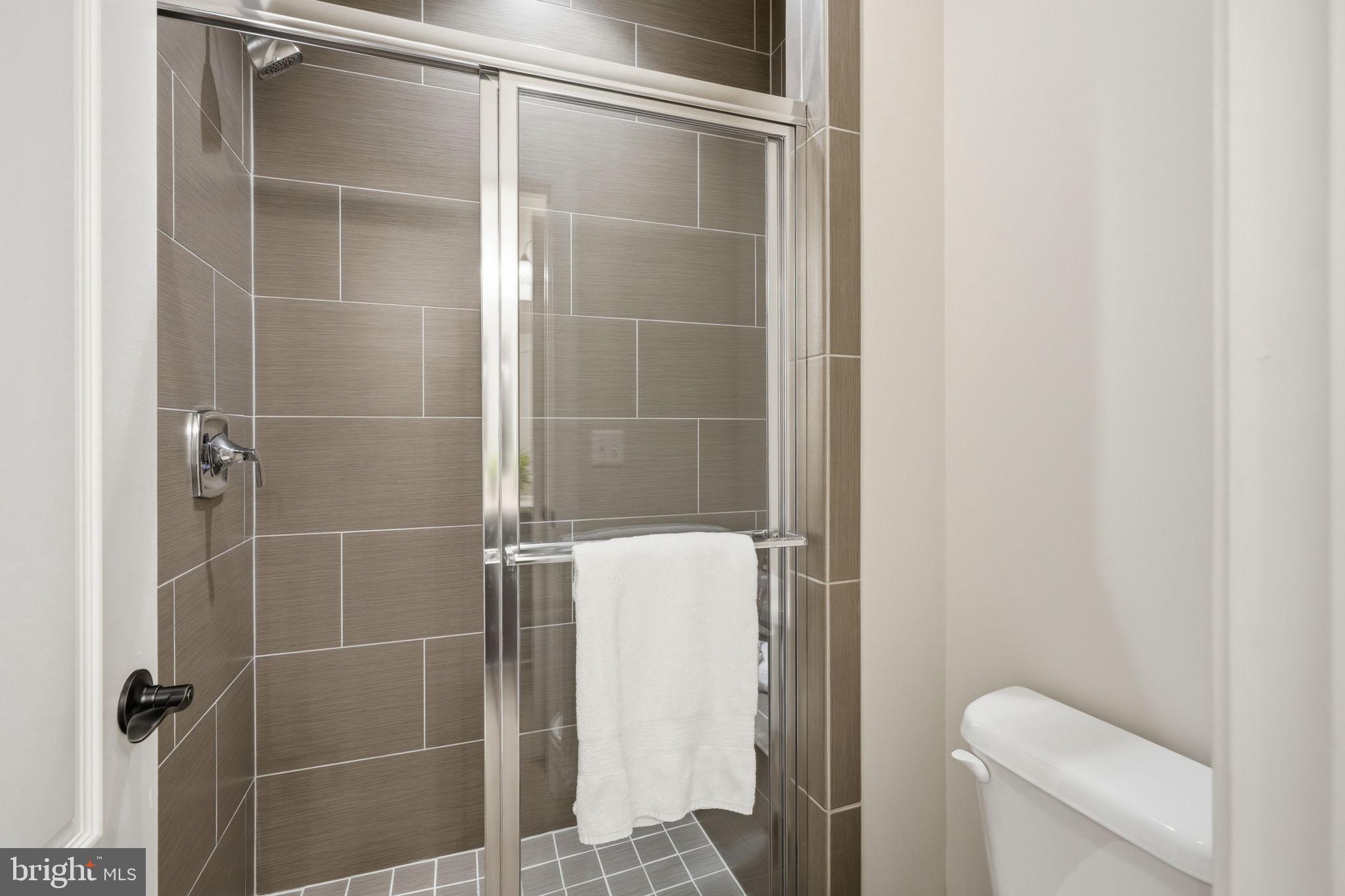 7821 Old Falls Road McLean, VA 22102 - Photo 35 of 62 a bathroom with a shower and toilet