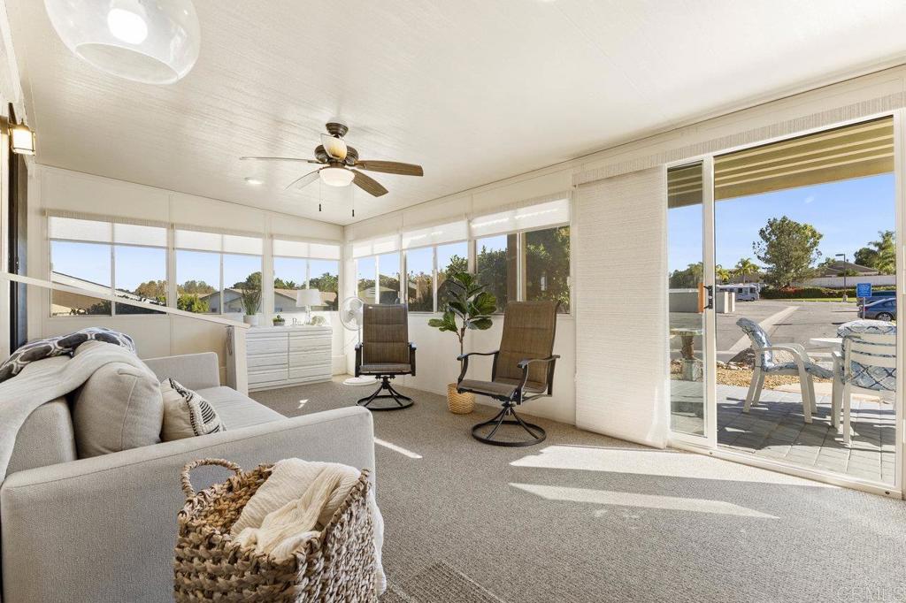 1476 Dover Street Oceanside, CA 92057 - Photo 16 of 45 a living room with furniture a floor to ceiling window and a flat screen tv