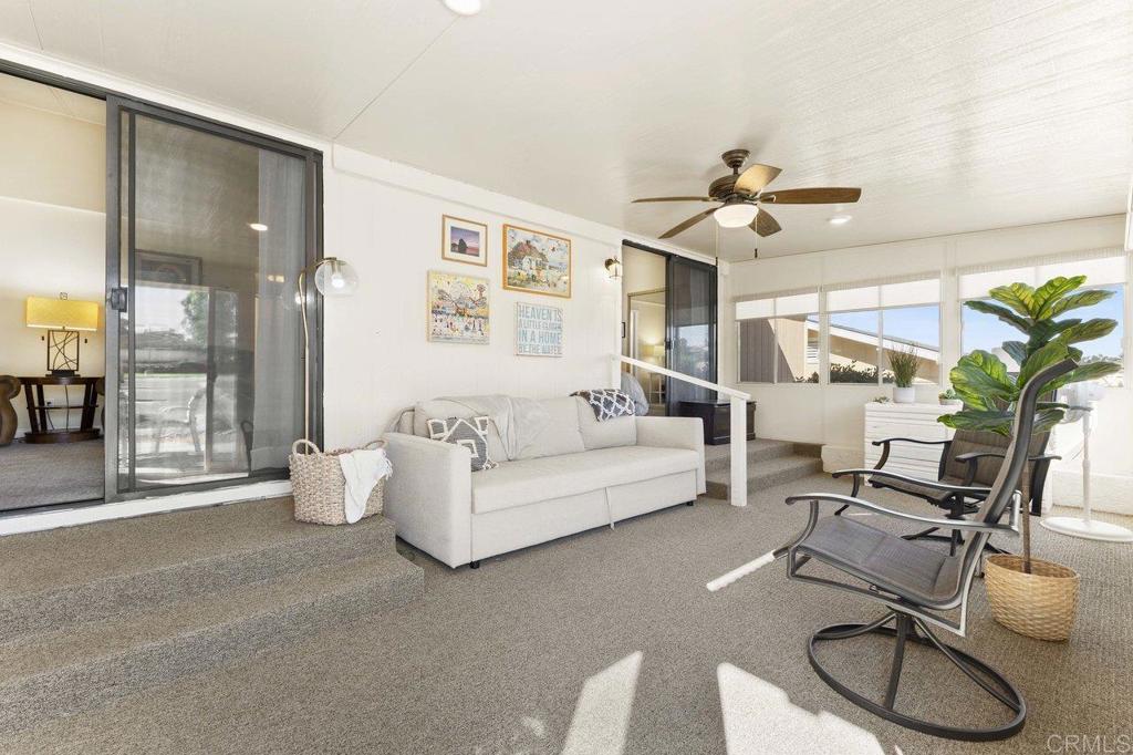 1476 Dover Street Oceanside, CA 92057 - Photo 17 of 45 a living room with furniture a chandelier and a glass door