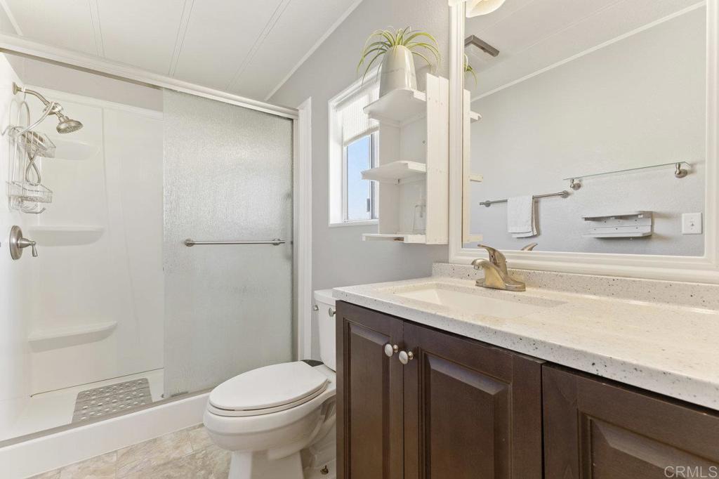 1476 Dover Street Oceanside, CA 92057 - Photo 25 of 45 a bathroom with a granite countertop sink toilet and shower