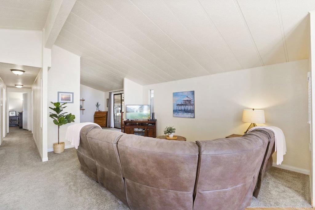 1476 Dover Street Oceanside, CA 92057 - Photo 6 of 45 a bedroom with a bed lamp and paintings on the wall