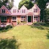 a front view of a residential houses with yard