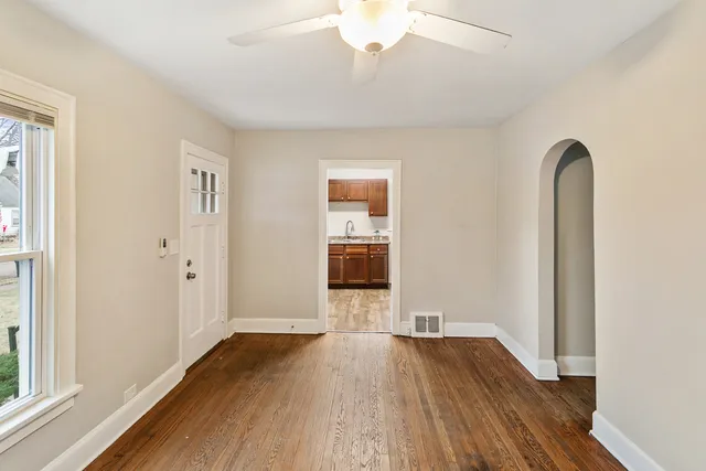 a view of a room with wooden floor and a window