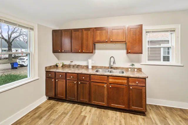 a kitchen with granite countertop a sink and cabinets