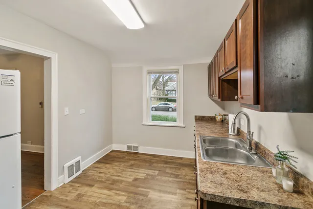 a kitchen with a granite countertop sink and a stove