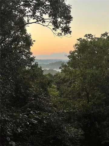 a view of mountain view with two trees in the background