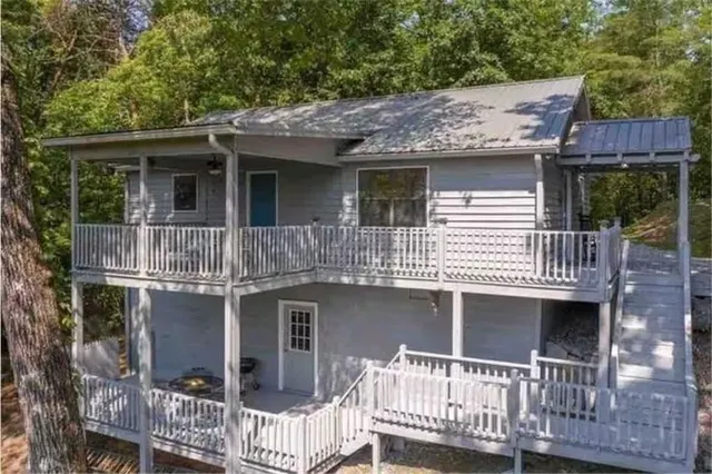 a view of a house with a yard and wooden fence