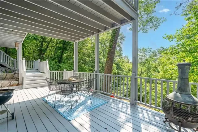 a view of a balcony with chairs and wooden floor