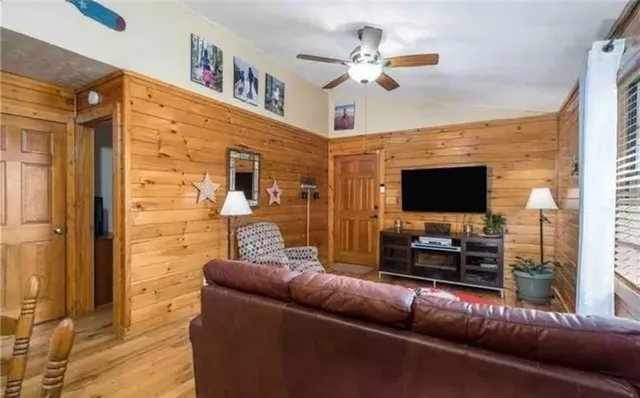 a living room with furniture and a flat screen tv