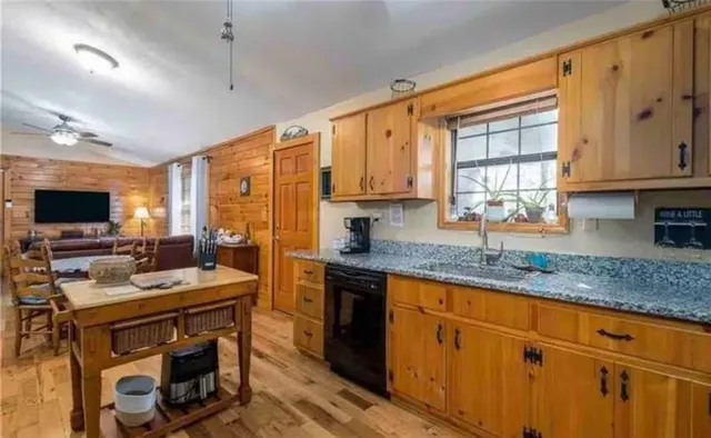 a kitchen with stainless steel appliances granite countertop a sink stove and cabinets