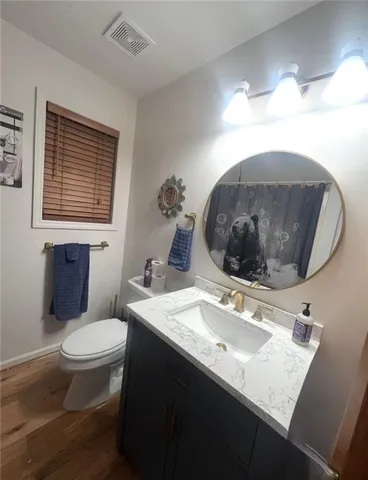 a bathroom with a sink toilet and mirror