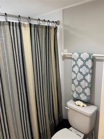 a bedroom with a bed and large windows