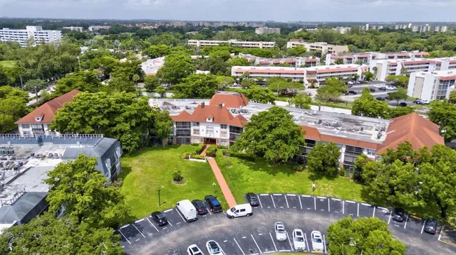 an aerial view of a house with a yard and lake view