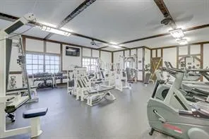 a room with pool table and windows