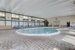 a front view of a house with a yard and potted plants