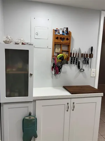 a kitchen with a refrigerator and cabinets