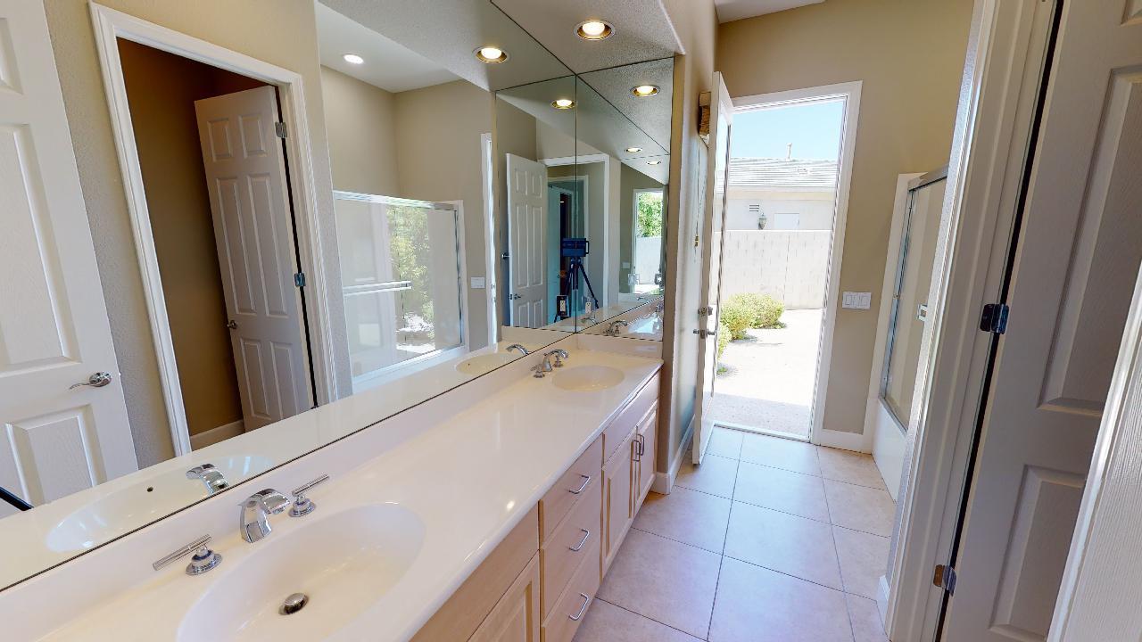 8 Picasso Court Rancho Mirage, CA 92270 - Photo 11 of 26 a spacious bathroom with a bathtub sink and mirror