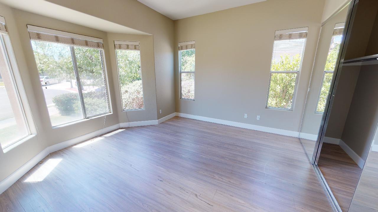 8 Picasso Court Rancho Mirage, CA 92270 - Photo 13 of 26 a view of an empty room with wooden floor and a window